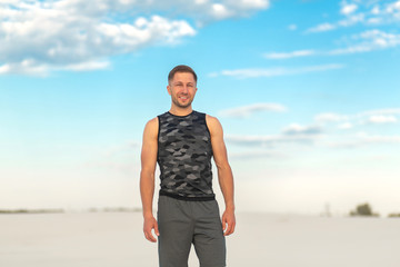 Portrait fit man in white sand desert