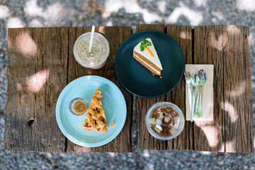 Coffee and cake, afternoon on a wooden table in the garden, top view