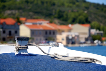 Rope tied on a small traditional wooden boat in town Vela Luka, on island Korcula, Croatia. Selective focus.