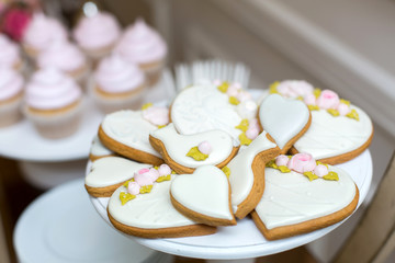 Gingerbread cookies and cookies on the festive table with sweets. Stylish pastries as a decoration for the holidays. Sweet bar