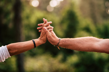 Concept of love and relationship for adult caucasian people with close up on pair of hands holding...