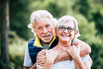 People in love at old age - couple of caucasian cheerful happy senior smile and hug in relationship...
