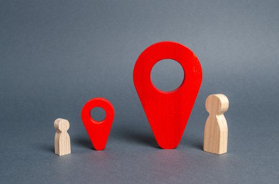 Small and big man near the red location pointers. The meeting place of the parent and child. significance of people. Social inequality of rights. Tracking kids. distance relationship,