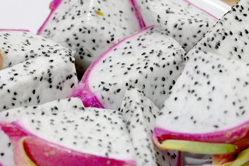 Healthy dragon fruit or pitaya pieces background, close up of beautiful fresh sliced dragon fruit with texture in the market in thailand. Pitaya is the plant in Cactaceae family or Cactus.