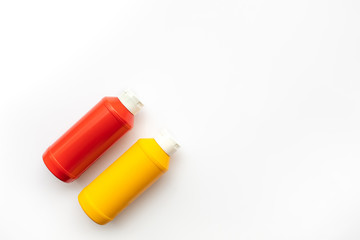 Bottles of sauce ( ketchup, mustard ) on white