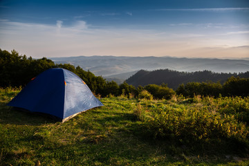 Beautiful mountain landscape with a tourist tent. Carpathian mountains of Ukraine. Holidays in the mountains.