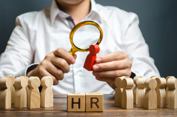The HR examines a candidate red figure. Recruiting new workers, headhunters Human resources. Search for talented worker. Assessment of qualities skills. Attraction of valuable personnel to the company