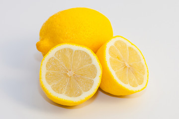 lemons and lemon slices on white background