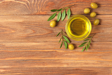 olive oil, green leaves and olives on the table top view.