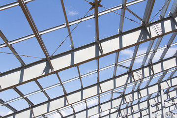 Fototapeta premium Steel structure of building construction on blue sky background