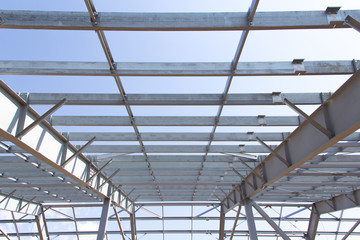 Steel structure of building construction on blue sky background