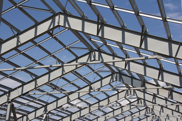 Steel structure of building construction on blue sky background
