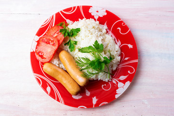 Boiled rice with sausages and herbs