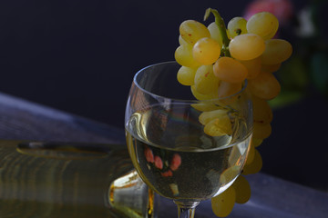 Grapes, white wine and glass