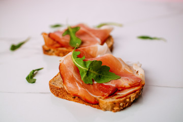 slice of bread with smoked ham on a white background