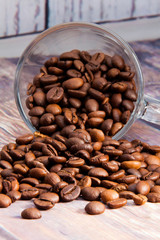Fototapeta premium coffee beans coming out of a glass cup
