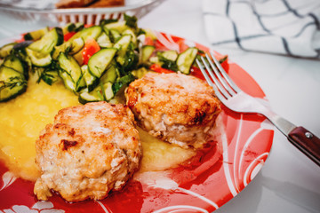 Meat cutlet with mashed potatoes and cucumbers