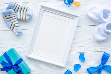birth of child - blank picture frame on wooden background