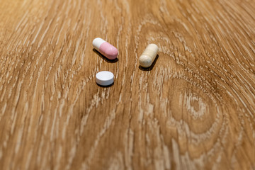 Capsules and pill on table