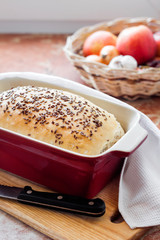 Homemade wheat bread with flax seeds in ceramic baking dish