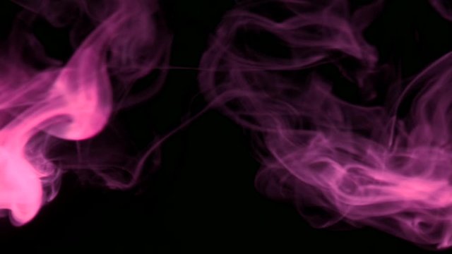 Vertical video screensaver - Trickle pink smoke slowly rising graceful twists upward. Colored smoke blowing from the left side. Closeup, isolated on black background.