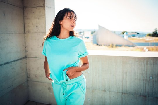 Young woman in blue clothes in urban setting