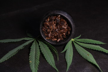 bowl with tobacco for hookah. fruits and berries on a black background. smoke hookah