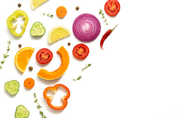 Colored slices of vegetables and fruits on a white background, isolated. Flat lay, top view, copy space.
