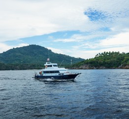 Fototapeta na wymiar Seascape - boat on background of tropical island