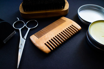 Materials for a perfect beard. Scissor, shaver, comb, wax and brush, all made with natural materials