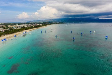 BORACAY, PHILIPPINES - 17 JUNE 2019: Sailing boats on Boracay Island's White Beach in the Philippines