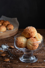 Coconut cookies in ice cream bowl on a wooden table.