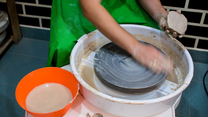 A raw clay pot in the hands of a potter. Workshop in the pottery workshop