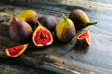 Whole and halved ripe organic delicious figs. Healthy nutritious vegan snack full of fiber and...
