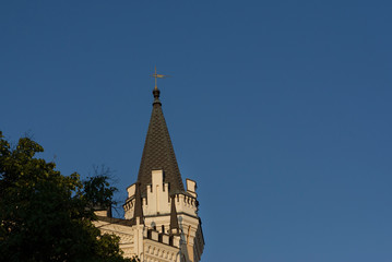 Fototapeta na wymiar Ancient tower of building on blue sky background