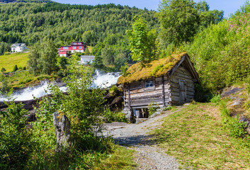 Fototapeta na wymiar Panorama of small village Hellesylt with Hellesyltfossen waterfall in along Geiranger fjord in More og Romsdal county in Norway