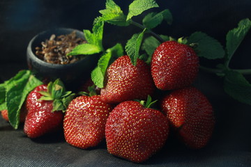bowl with tobacco for hookah. fruits and berries on a black background. smoke hookah