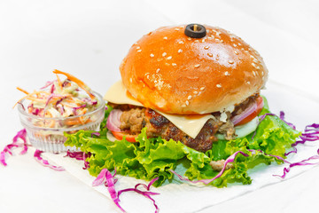 A big size Burger Patties from Ground Beef with Lettuce leaf and Coleslaw Salad.