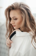 Fototapeta premium Portrait of beautiful young blonde woman with makeup in fashion clothes