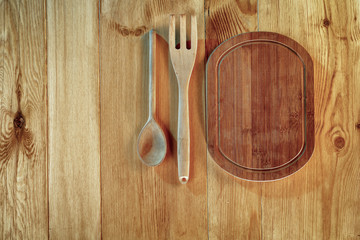 Kitchen tools and utensils on wooden board. Copy space for text, products and decorations.