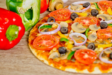 Popular colorful ingredients as like tomatoes, cheese, mushroom, capsicum, olives and other ingredients baked healthy Pizza.
