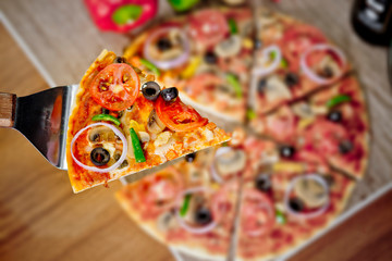 Popular colorful ingredients as like tomatoes, cheese, mushroom, capsicum, olives and other ingredients baked healthy Pizza.