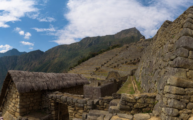 Fototapeta na wymiar Buildings, walls and terraces of the mystic Inca city Machu Picchu in the Andes, Peru