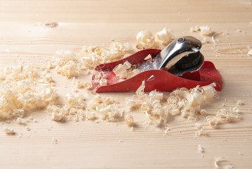Planer, shavings and sawdust on a wooden workbench