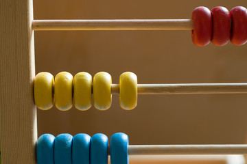 Children's colorful abacus for counting with yellow, red, and blue wooden beads