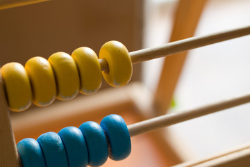 Children's colorful abacus for counting with yellow and blue wooden beads