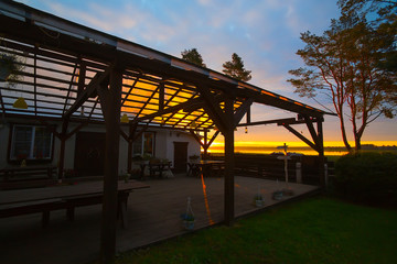 the rays of the setting sun Shine through the canopy with wooden flooring at home.