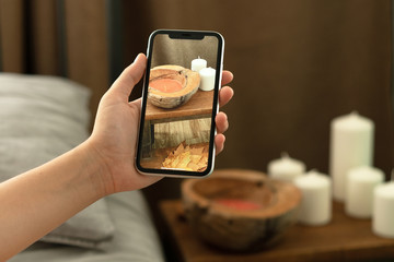 Woman hands using mobile phone takes photo at hotel room cozy bedroom blurred background