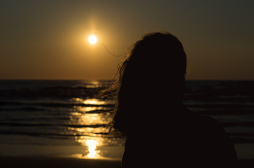 Woman at the Evening Beach at Sunset Time.