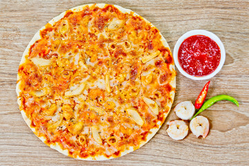 Classic Seafood Pizza with spicy chilli sauce.